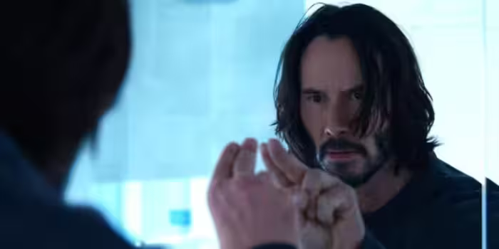 Neo looks at a mirror in the mat